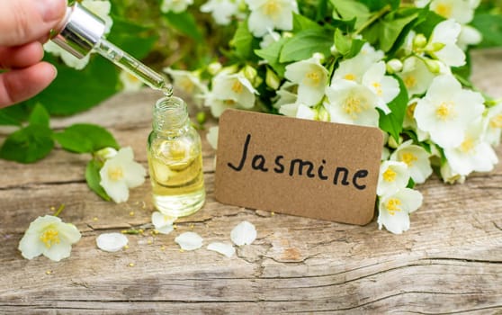 Jasmine essential oil and flowers. Selective focus. nature.