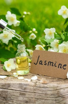 Jasmine essential oil and flowers. Selective focus. nature.