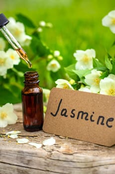 Jasmine essential oil and flowers. Selective focus. nature.