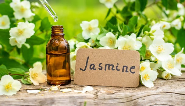 Jasmine essential oil and flowers. Selective focus. nature.