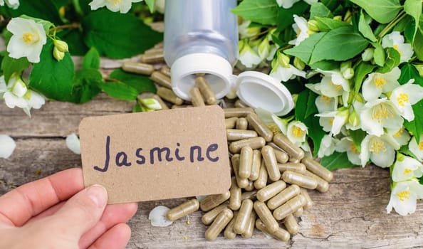 Jasmine essential oil and flowers. Selective focus. nature.
