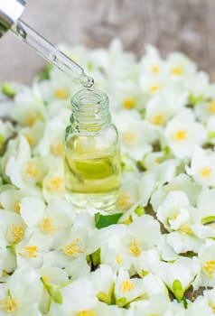 Jasmine essential oil and flowers. Selective focus. nature.