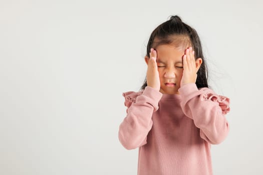 Portrait of Asian young kid girl sad tired strain face holding hold head by hands, stress kindergarten child person unhappy closed eyes problem headache, studio shot isolated on white background