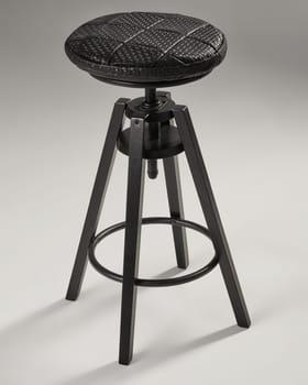 Adjustable height bar stool featuring a black woven leather seat and tripod base, ideal for modern kitchen islands