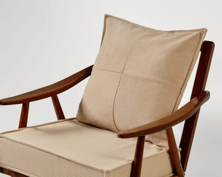 Modern armchair with beige corduroy upholstery and a matching cushion, showcasing a minimalist and stylish design
