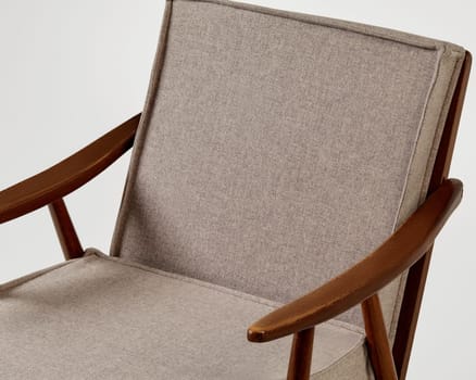 Comfortable modern armchair with wooden frame and soft beige upholstery offers a stylish seating solution