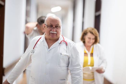 Medical personnel, including doctors and nurses, urgently respond in a busy hospital hallway, showcasing their quick action and teamwork in a critical situation