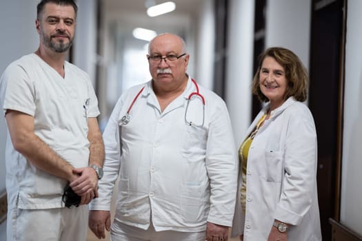 A team of experienced doctors standing in the hospital hallway, weary but dedicated after a long day of caring for patients