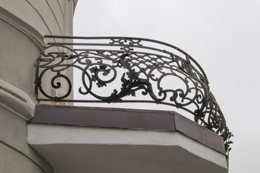 Forged semicircular balcony lattice fence with monograms, closeup.