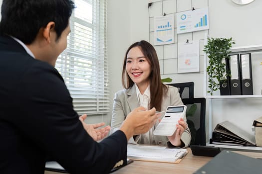 A cheerful financial consultant shares effective strategies with a client, fostering a positive and collaborative atmosphere.