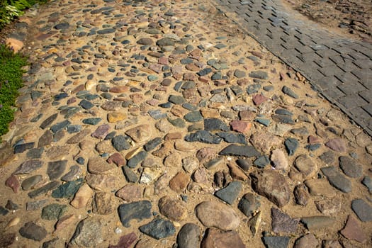 Close-up of a cobblestone street paved with ancient round stones.
