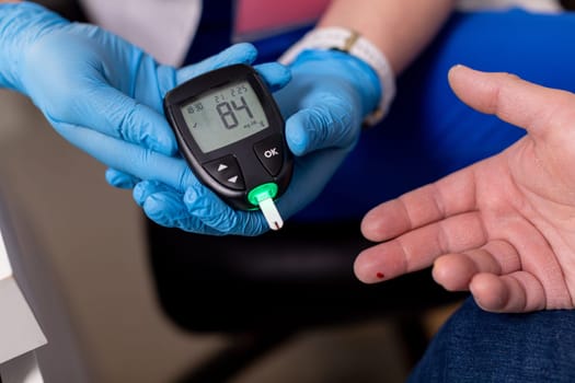 A dedicated healthcare professional is demonstrating the method of blood glucose monitoring using a specific device