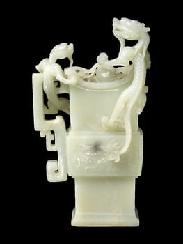 Elegant 18th-19th century Chinese vase carved from pale jade in an archaic style, featuring intricate dragon motifs. Smooth texture, symbolic of power and good fortune.