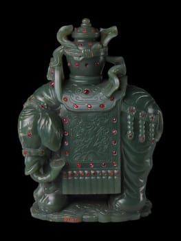 Intricate 18th-19th century Chinese carving of a dark green jade elephant carrying a vase, adorned with red accents. Symbol of strength and peace.