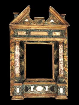 Detailed view of an early 17th-century Italian tabernacle frame from the Marches region. Features ornate gilded elements, dark textured columns, and intricate architectural details. Evokes historical elegance and artistic heritage.