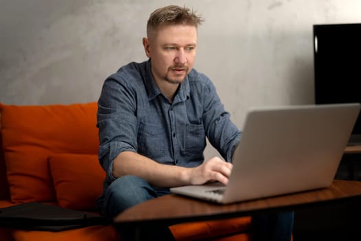 Man Working Remotely On Laptop At Home