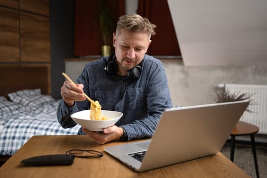 Man Eating Dinner At Laptop At Home