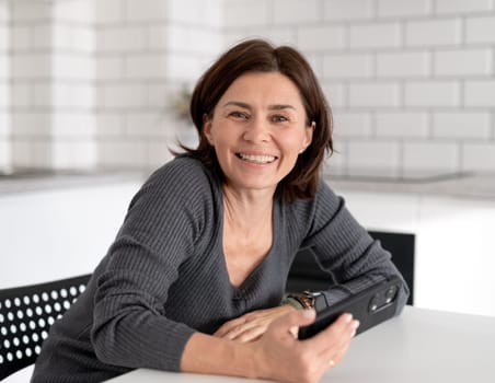 Young Woman Smiles At Home In Bright Room