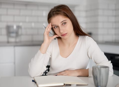 Focused Girl Writing In A Notebook Preparing For Classes At The Lyceum