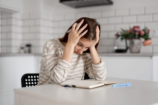 Girl Holding Head Over Difficult Homework Notes