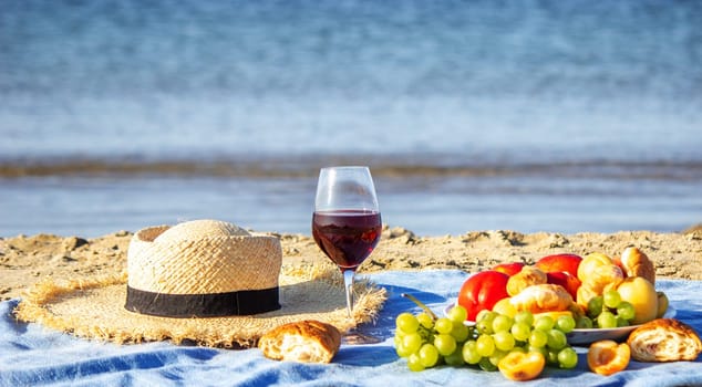 Two glasses of wine and fruit against the sea background