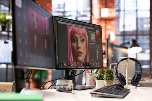 Modern creative office for a photo editor with AI and retouching software, showing an empty desk with computer running advanced design program. Artistic digital media adjustments.