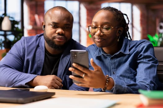 Smiling couple hosting a virtual family meeting via video call online, meeting with the relatives and sharing latest news. Man and woman at home use web connection to keep in touch with loved ones.