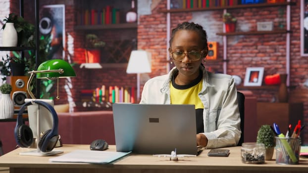 Freelancer in home office opening laptop, starting working on tasks. Remote employee using electronic device to do customers relations job online, answering inquiries, camera B