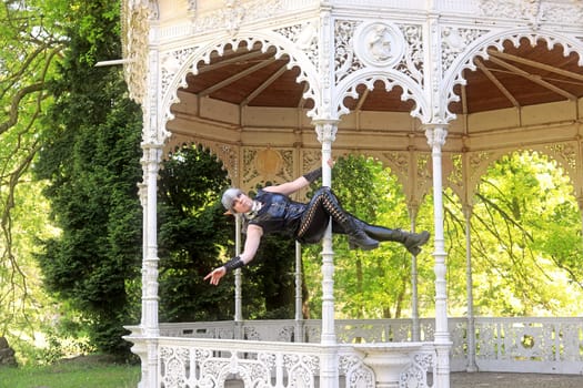 Fantasy shot of a dark elf on the pole of an old pavilion