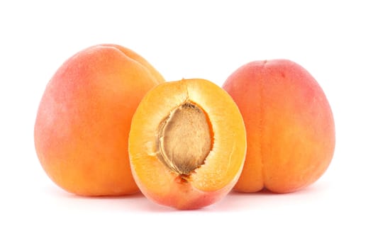 Fresh and juicy apricots with vibrant orange-yellow skin, displayed in a group with one fruit sliced open to reveal the stone inside. Ideal for healthy eating and vibrant fruit themes.