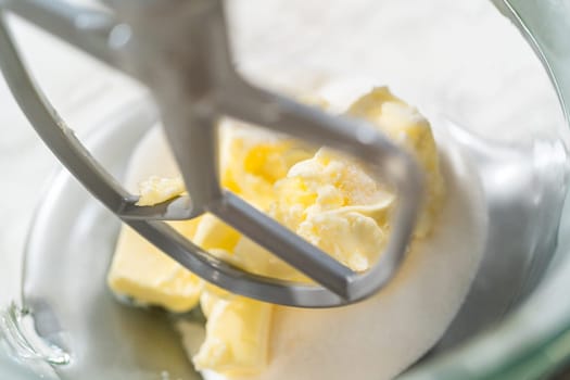 Close-up of a stand mixer creaming together butter and sugar for the Chocolate Ginger Sugar Cookie Dough, creating a light, fluffy base.