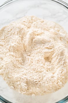 Close-up of flour in a mixing bowl, creating a smooth, sifted base for Pale Gingerbread Cookies with Subtle Spice Flavor. Ready for spices to be added.