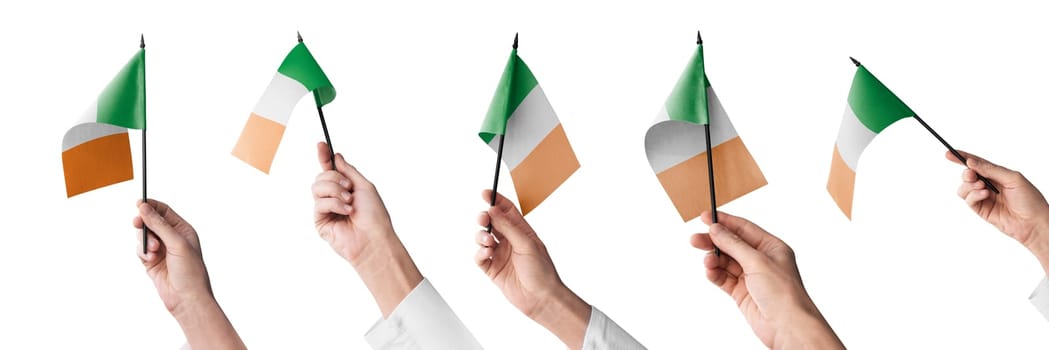 The Ireland flag in hand in different angles on a white background.