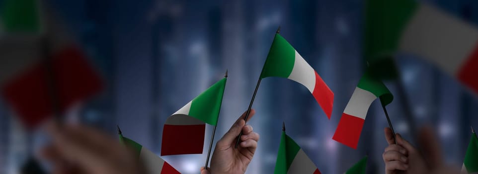 Italy flags in their hands on a blurred urban background. The photo illustration was created without the use of artificial intelligence, only using Photoshop.