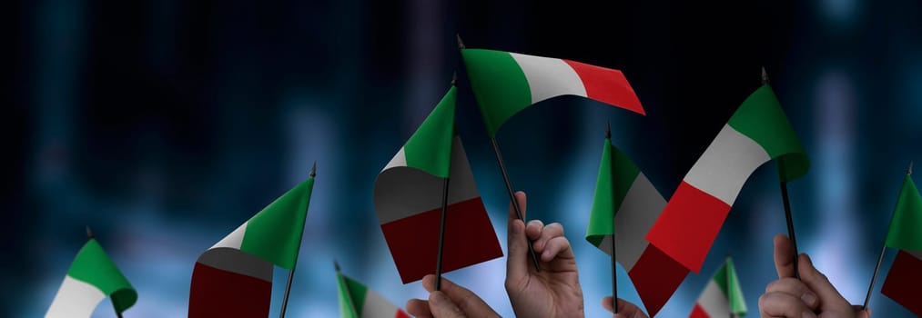 Italy flags in their hands on a blurred urban background. The photo illustration was created without the use of artificial intelligence, only using Photoshop.