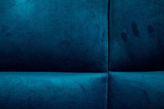 A close-up of rich blue upholstery shows texture and patterns, showcasing soft fibers and subtle variations in color. Ideal for design inspiration and textile analysis.