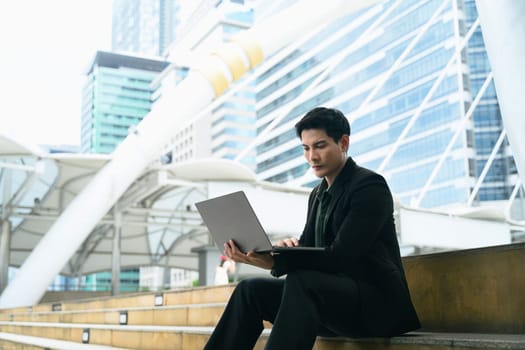 Urban businessman in formal attire outdoors in a financial district.