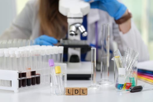 In a contemporary laboratory setting, a dedicated scientist meticulously examines LDL levels under a microscope