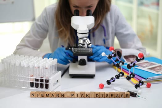 A dedicated scientist examines samples under a powerful microscope for NiemannPick Disease research