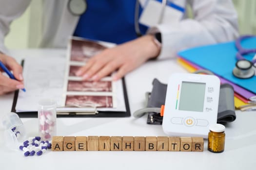 A dedicated doctor meticulously studies patient data while managing ACE inhibitor medication and various health tools