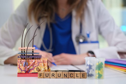 A detailed model illustrating a furuncle, with medical tools and a doctor's focus in the background.
