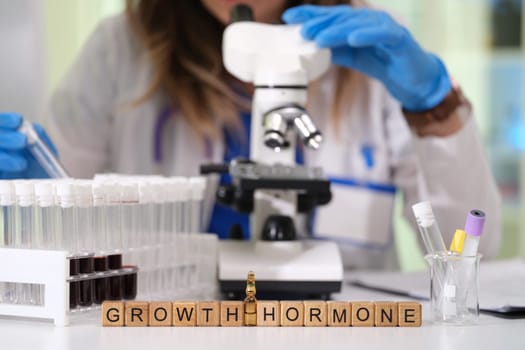 Engaging in detailed research on growth hormone by utilizing a microscope alongside various laboratory samples