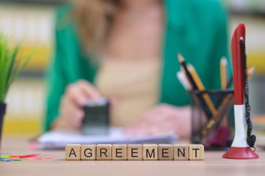 An important agreement is being carefully prepared on a desk full of stationery, highlighting professionalism