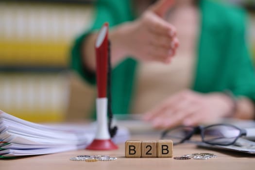 A professional environment that emphasizes B2B partnerships with important papers to sign and a firm handshake