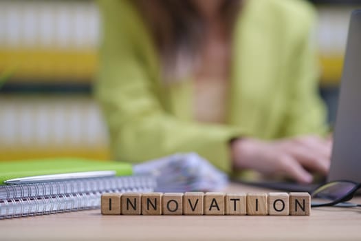 A closeup of a vibrant workspace shows blocks labeled INNOVATION, symbolizing creativity and progress