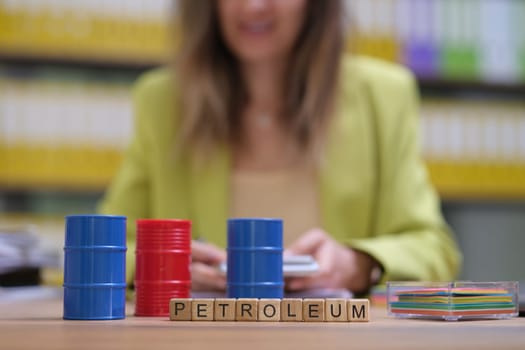 A creative representation of petroleum resources and industry concepts through color-coded barrels and letters.