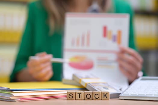 A professional is analyzing stock performance using charts and financial data to gain strategic insights