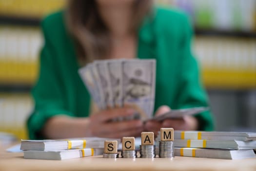 A compelling image showcasing the serious issue of financial scams with cash and blocks spelling 'SCAM'.