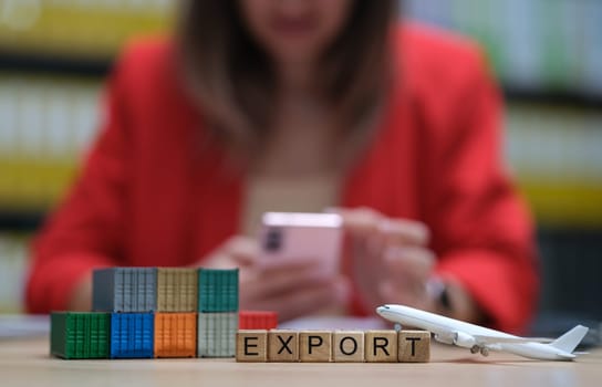 A visual representation of export with blocks, airplane, and mobile phone in a professional setting.