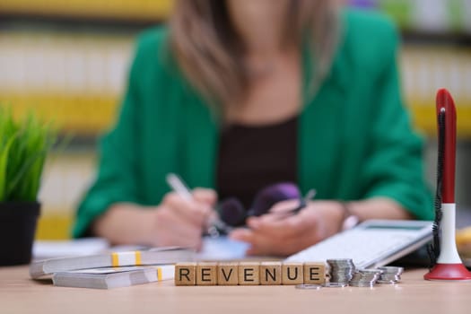 A highly skilled professional is analyzing revenue data using advanced tools in a modern office environment